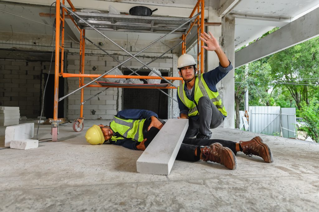 Construction worker injured by falling concrete block on job site while coworker signals for help Construction worker injured by falling concrete block on job site while coworker signals for help