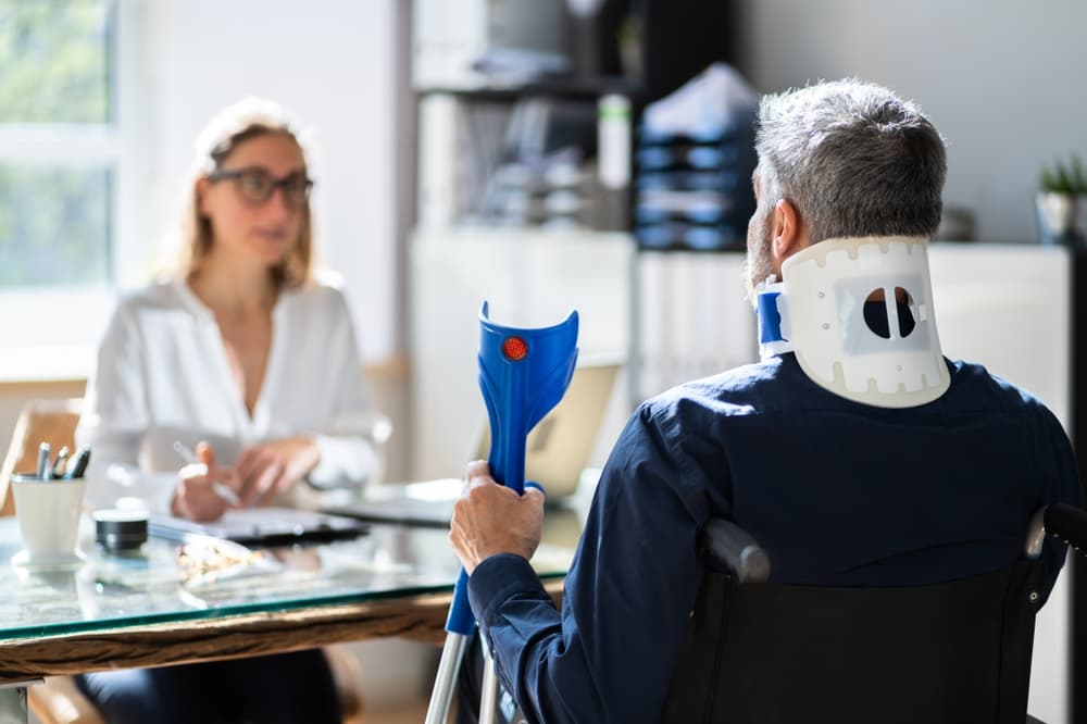 Workers' compensation attorney discussing case with injured worker