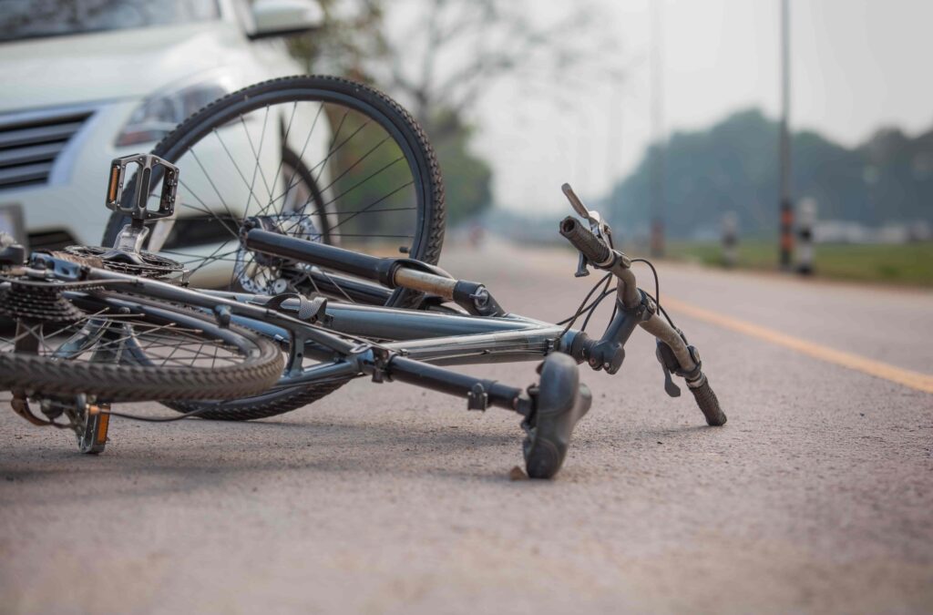 Bicycle accident on the road after collision with car Bicycle accident on the road after collision with car
