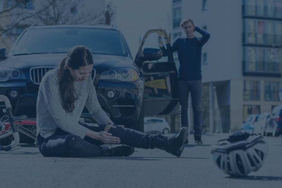 bicyclist laying on ground after accident