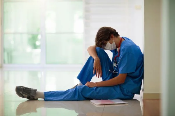Stressed male nurse after negligence